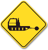 snow grooming vehicle warning sign at tremblant ski resort indicating active grooming machines operating on mountain trails