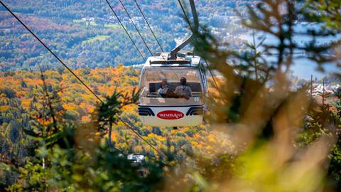gondola ride at tremblant resort offering scenic views of lake tremblant and forested hills in fall