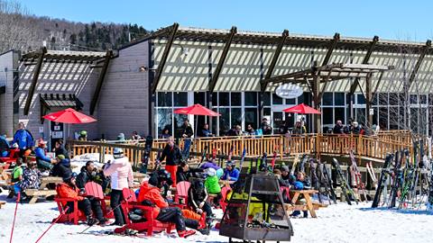 Ski-in ski-out dining at Mont-Tremblant featuring the base lodge restaurant La Fourchette du Diable, a convenient lunch spot for guests staying in mountain vacation rentals.