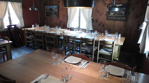 Rustic interior dining area of La Savoie restaurant in Tremblant.