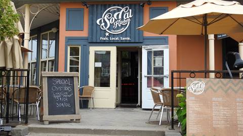 Exterior entrance of SoCal Kitchen at Mont-Tremblant featuring an outdoor patio
