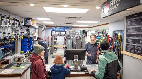 Technicians assisting customers at Le Ski Shop repair and wax station in Tremblant.